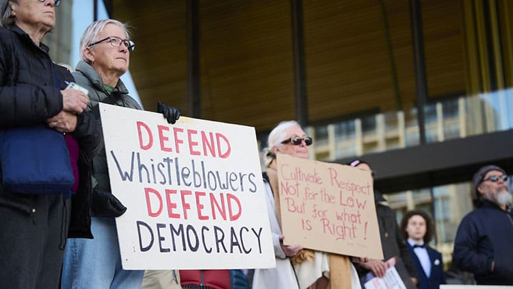 Democratic Freedoms banner of whistleblower rally